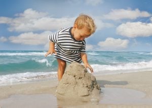 baby boy playing on beach